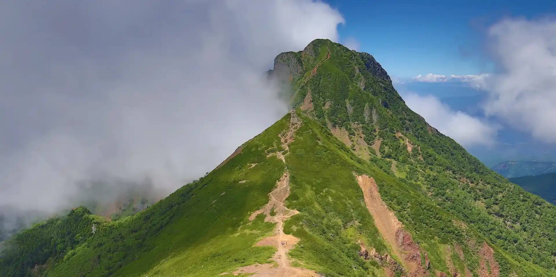 A mountain ridge wrapped in clouds